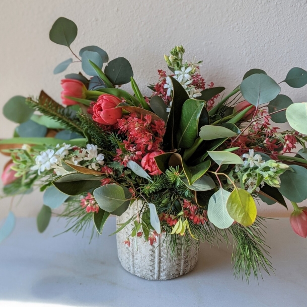 Heaven Scent floral arrangement with red tulips, eucalyptus and mixed blooms in a textured vase